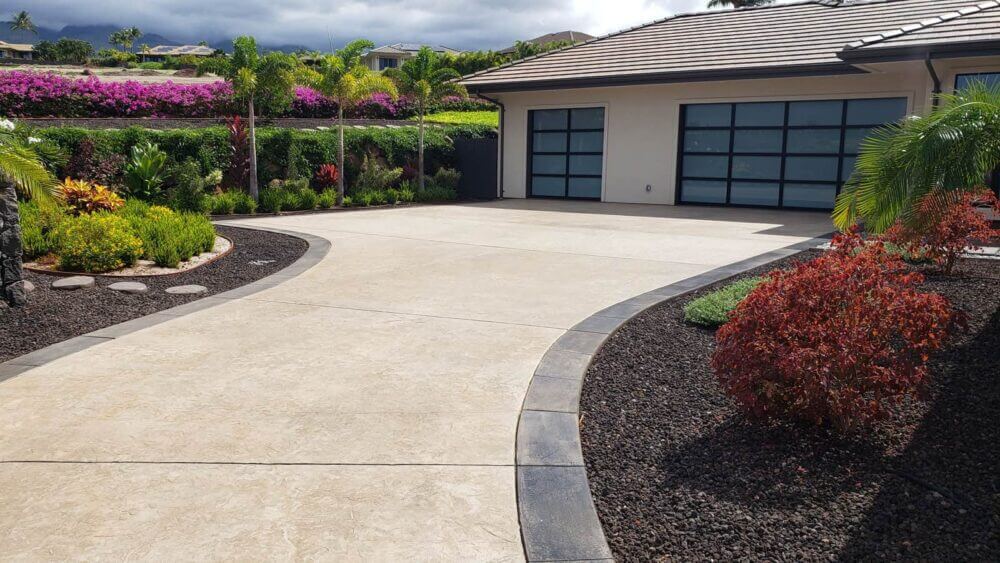 Decorative concrete driveway in front of garage.